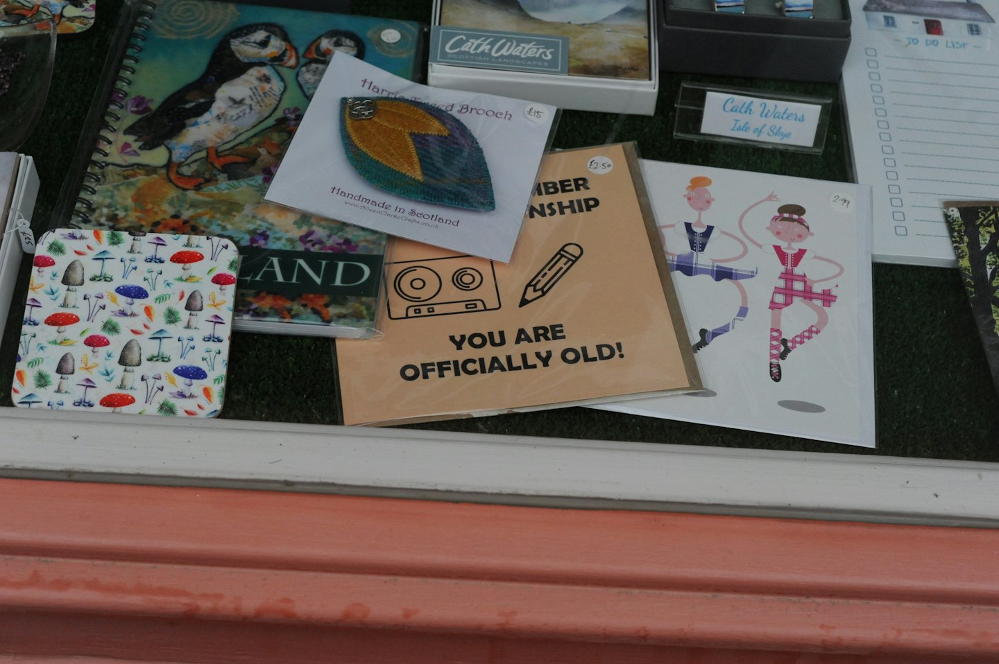 Assorted gift shop items arranged neatly on a green surface.